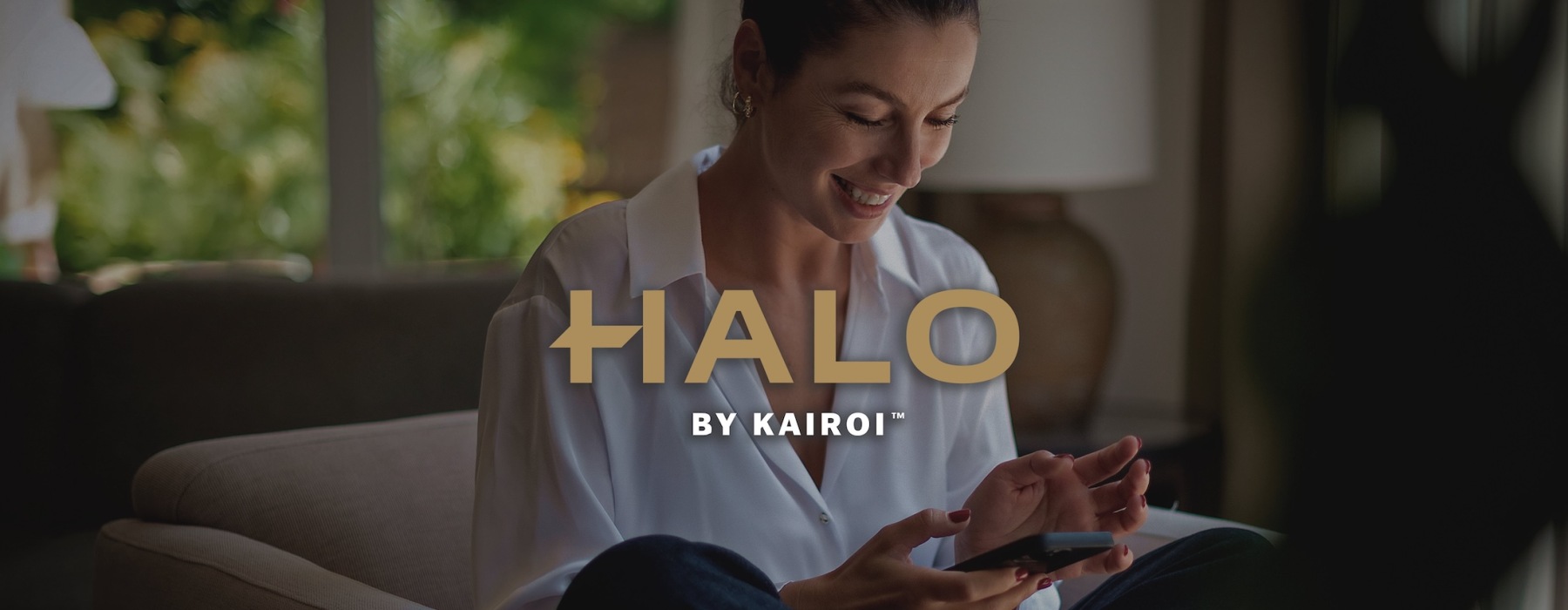 a woman smiling and interacting with her device