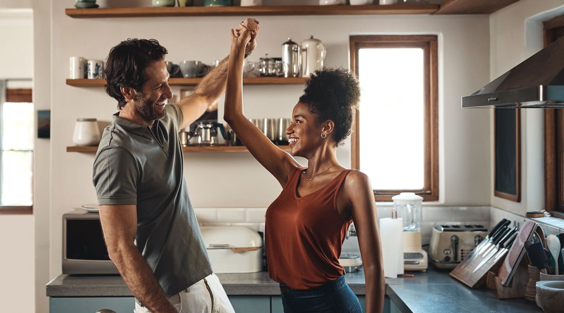 man and woman dancing in kitchen